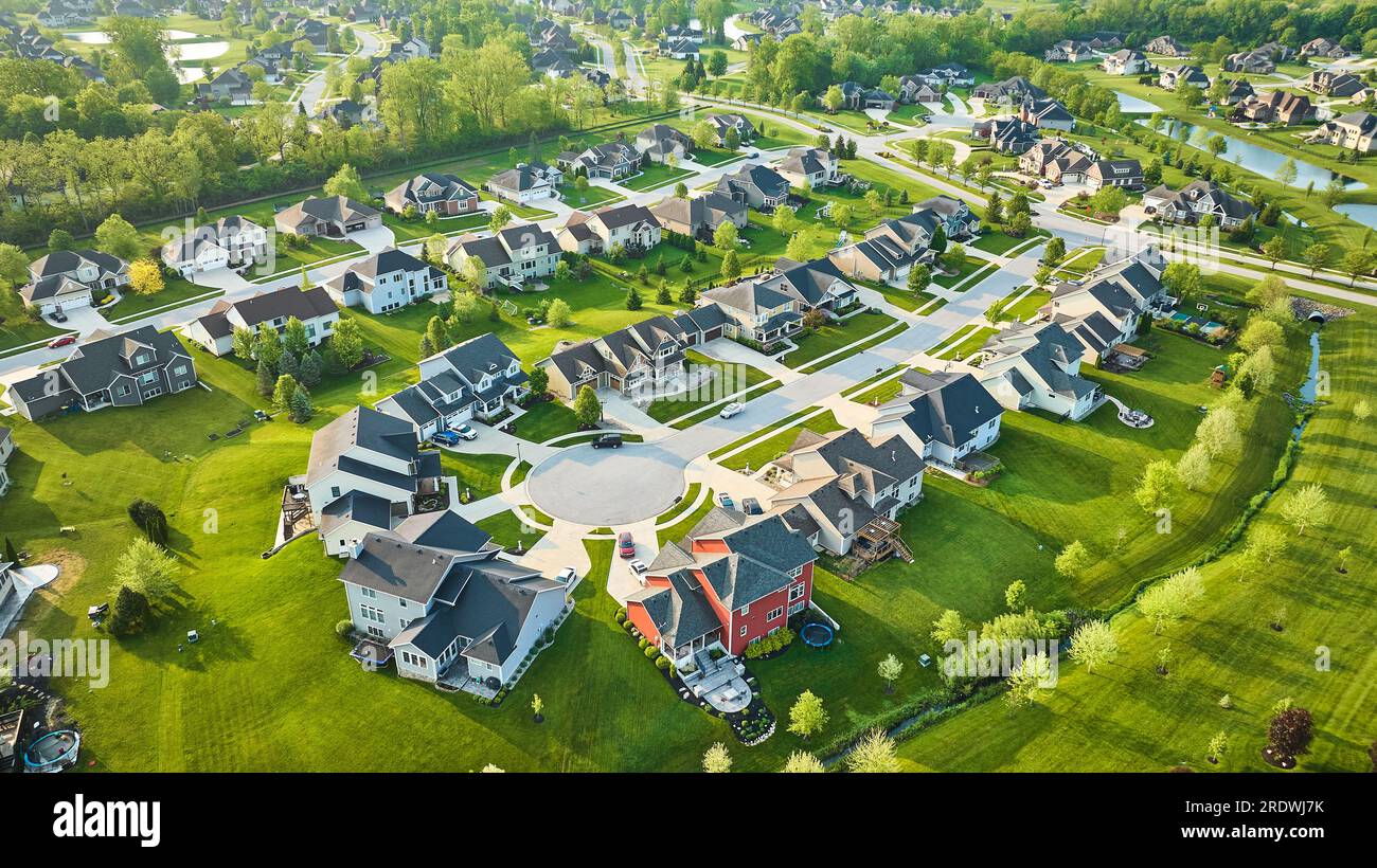 Mini mansion homes in rich neighborhood with lush landscaping in summer Stock Photo Alamy