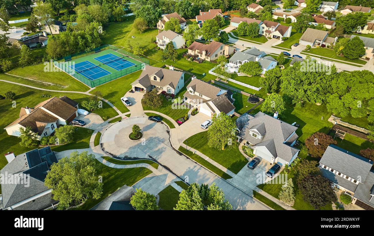 Culdesac houses in neighborhood with tennis court amenity aerial