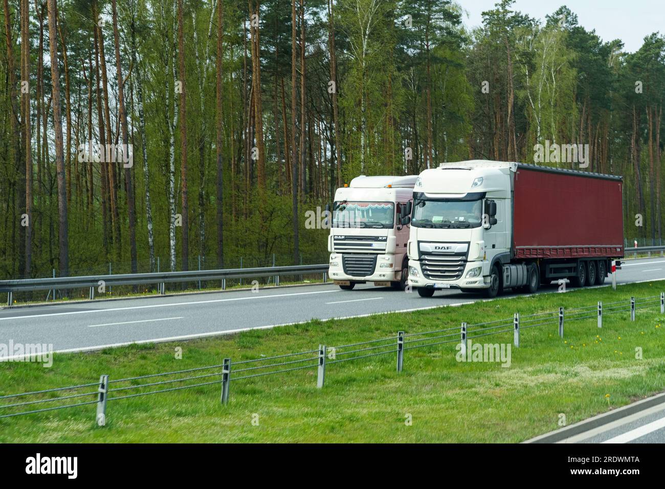 Wilczy Las, Poland - April 24, 2023: The movement of cargo transport transporting goods in tilt semi-trailers. Stock Photo