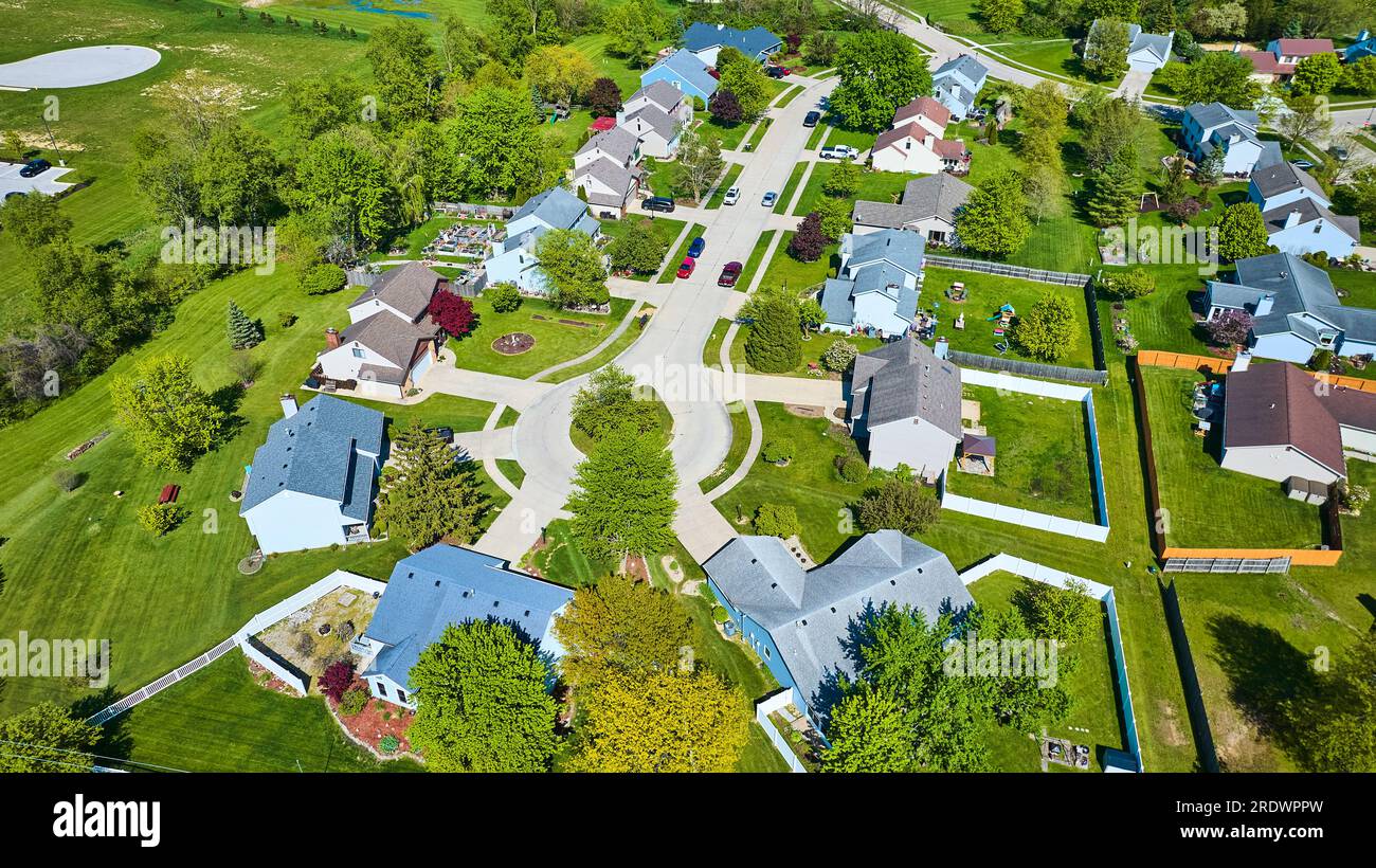 White picket fences in HOA neighborhood in summer with white roads cul