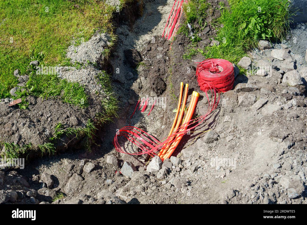 fiber optic cables been installed underground in dug trenches front of ...