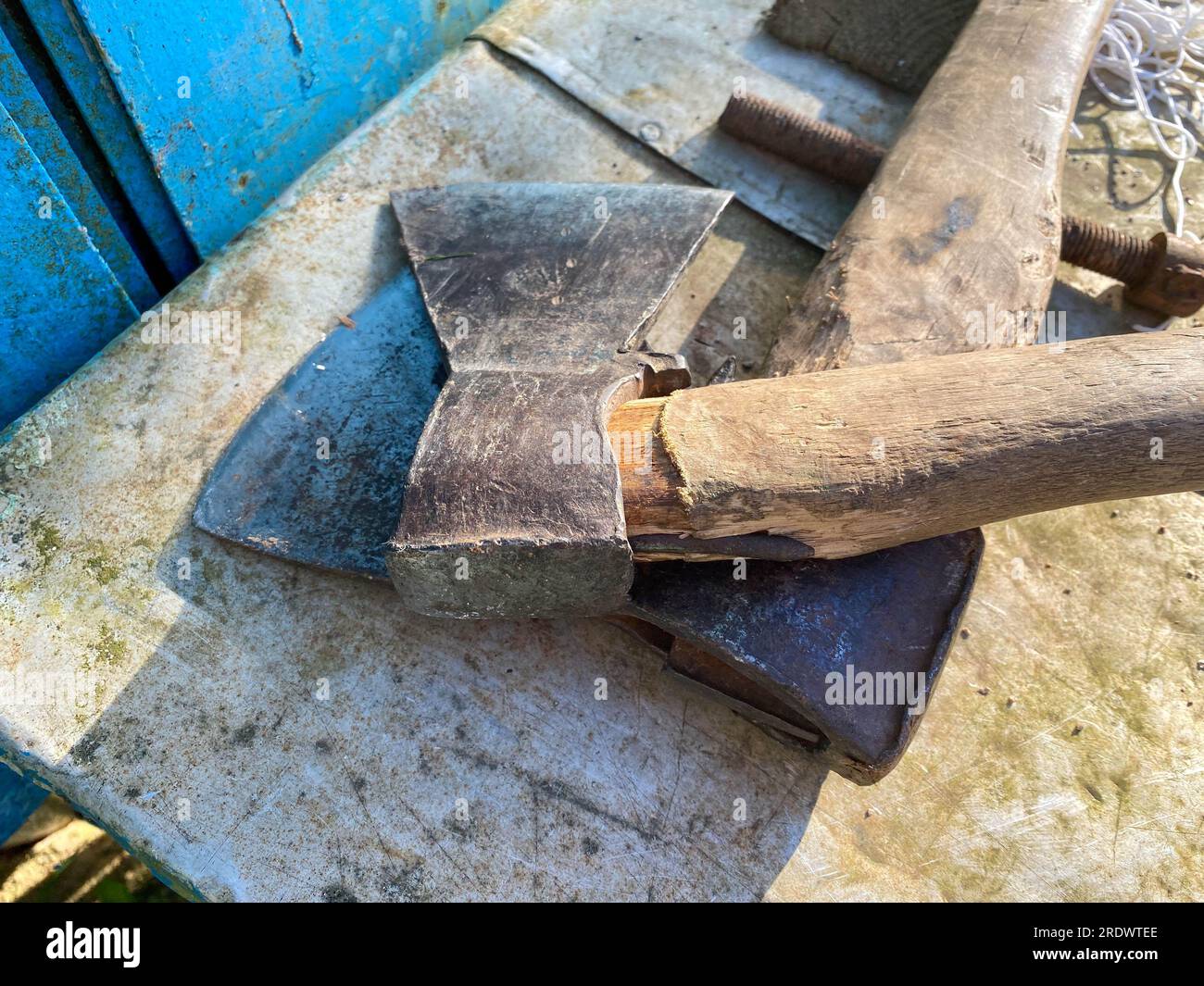 Set of iron tools ax hammer closeup old wooden handle weathered on