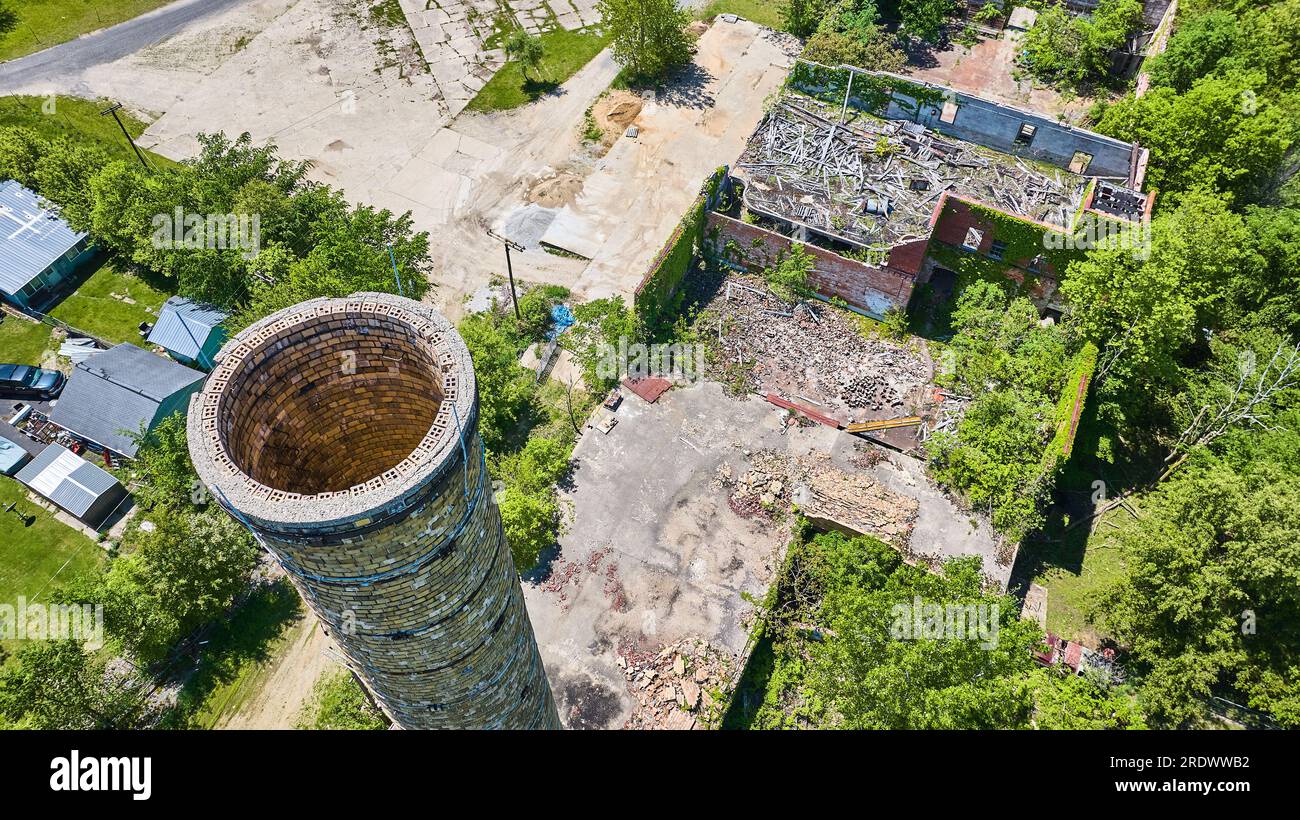 Timber Stack Silo Aerial smokestack silo brick at old abandoned farm building with green ...