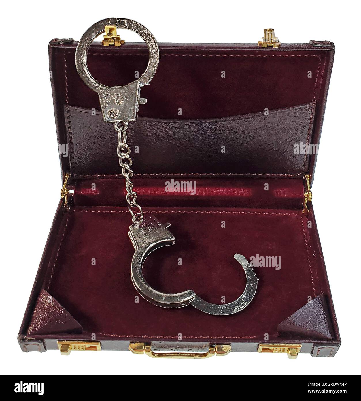 A pair of silver handcuffs hanging on the inside of a briefcase Stock Photo
