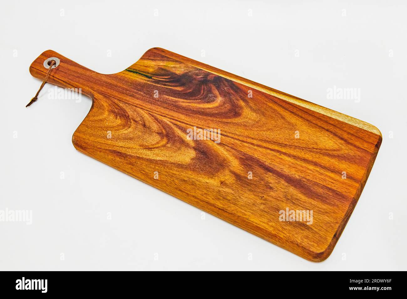 Wooden cutting board with small handle on a white background Stock Photo