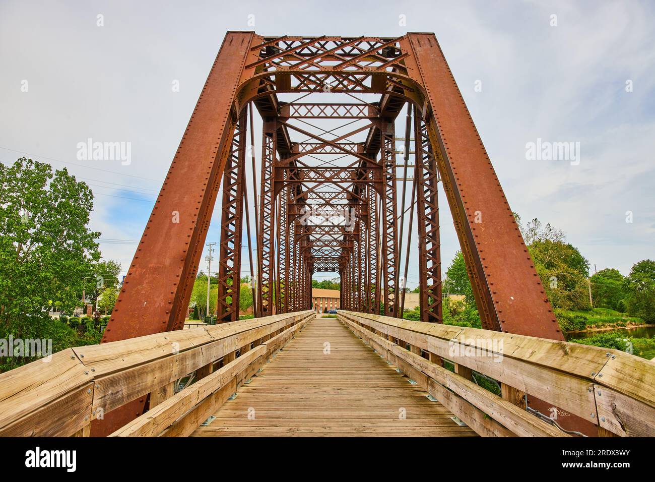 View of building through converted railroad bridge now wooden walking bridge in Mount Vernon