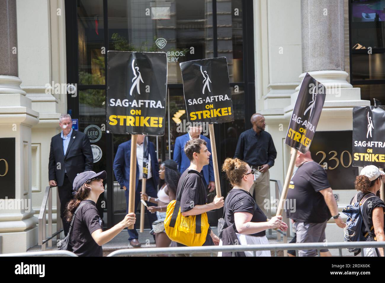 New York City: The strike continues among Writers Guild of America along with SAG-AFTRA  Union members with picket lines in multiple locations in in Manhattan crippling the entertainment industry. Union members picket in front of Warner Brothers building in Manhattan. Stock Photo