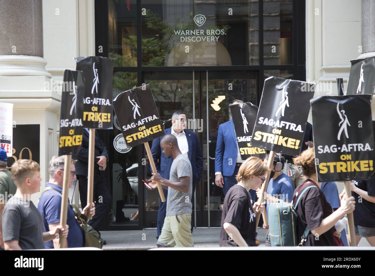 New York City: The strike continues among Writers Guild of America along with SAG-AFTRA  Union members with picket lines in multiple locations in in Manhattan crippling the entertainment industry. Union members picket in front of Warner Brothers building in Manhattan. Stock Photo