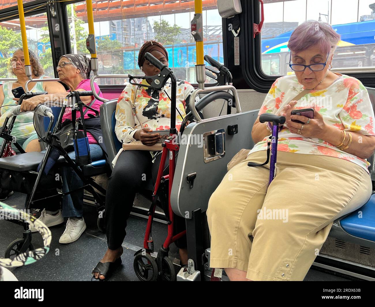 Many older people use the public bus system and often need walking aids like canes or walkers. MTA bus, Brooklyn, New York. Stock Photo