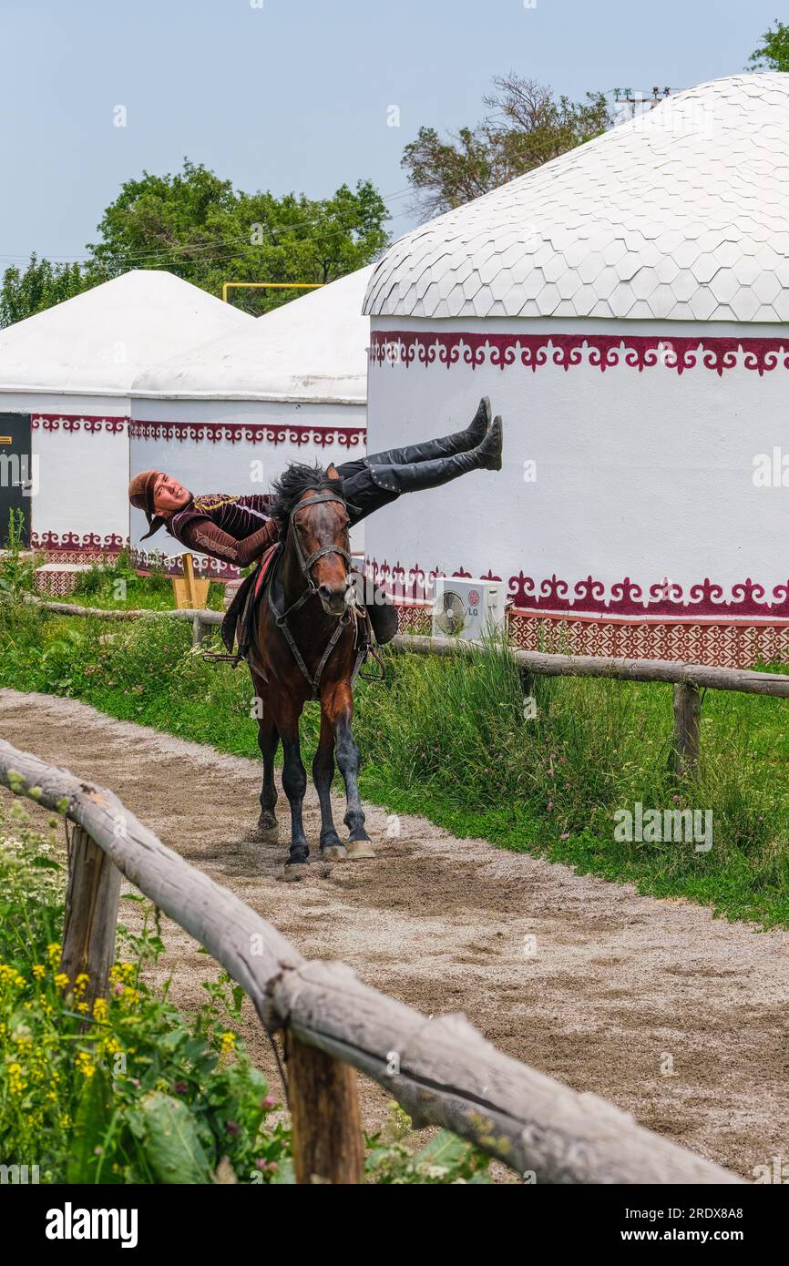 Kazakhstan, Huns Ethno Village. Demonstration of Traditional Kazakh Nomadic Riding Skill. Stock Photo
