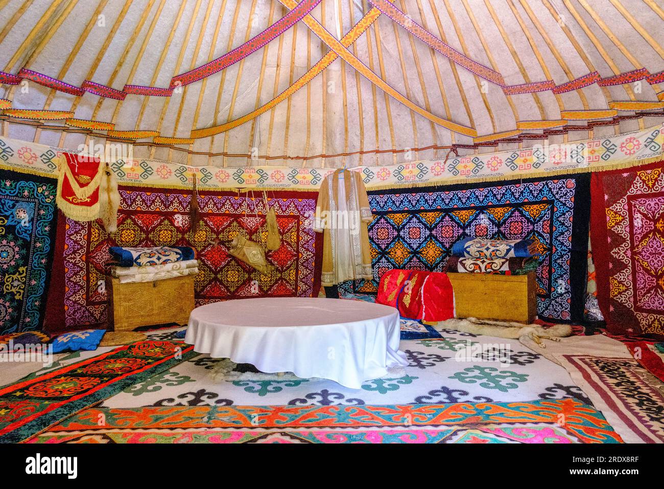 Kazakhstan, Huns Ethno Village. Yurt Interior Showing Floral and Geometric Fabric Decorations. Stock Photo