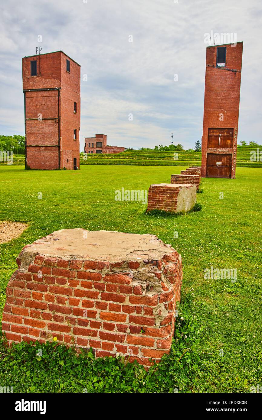 Busted brick and concrete pillars and distant abandoned freight ...