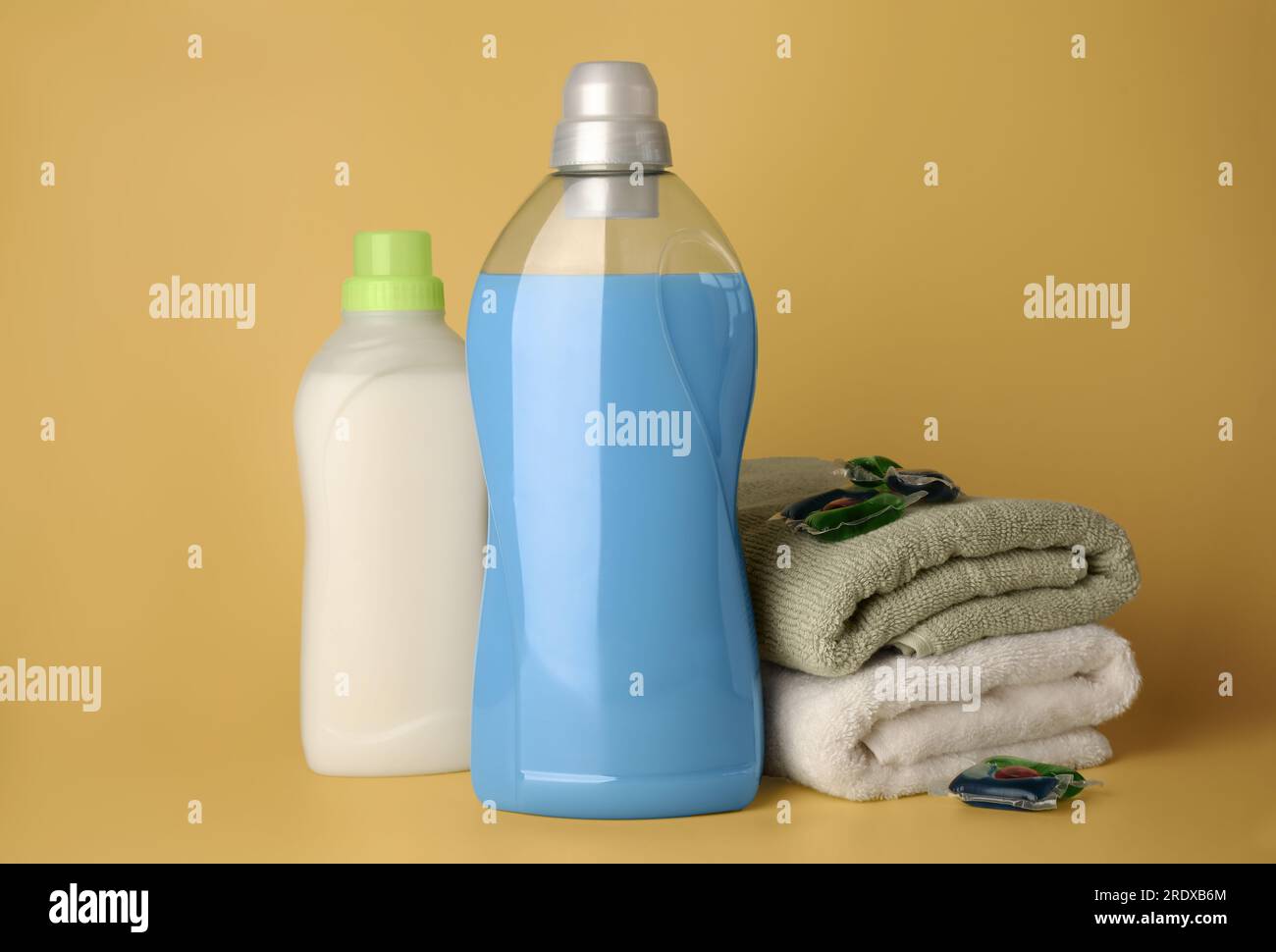 Bottles of fabric softener, laundry detergent capsules and stacked