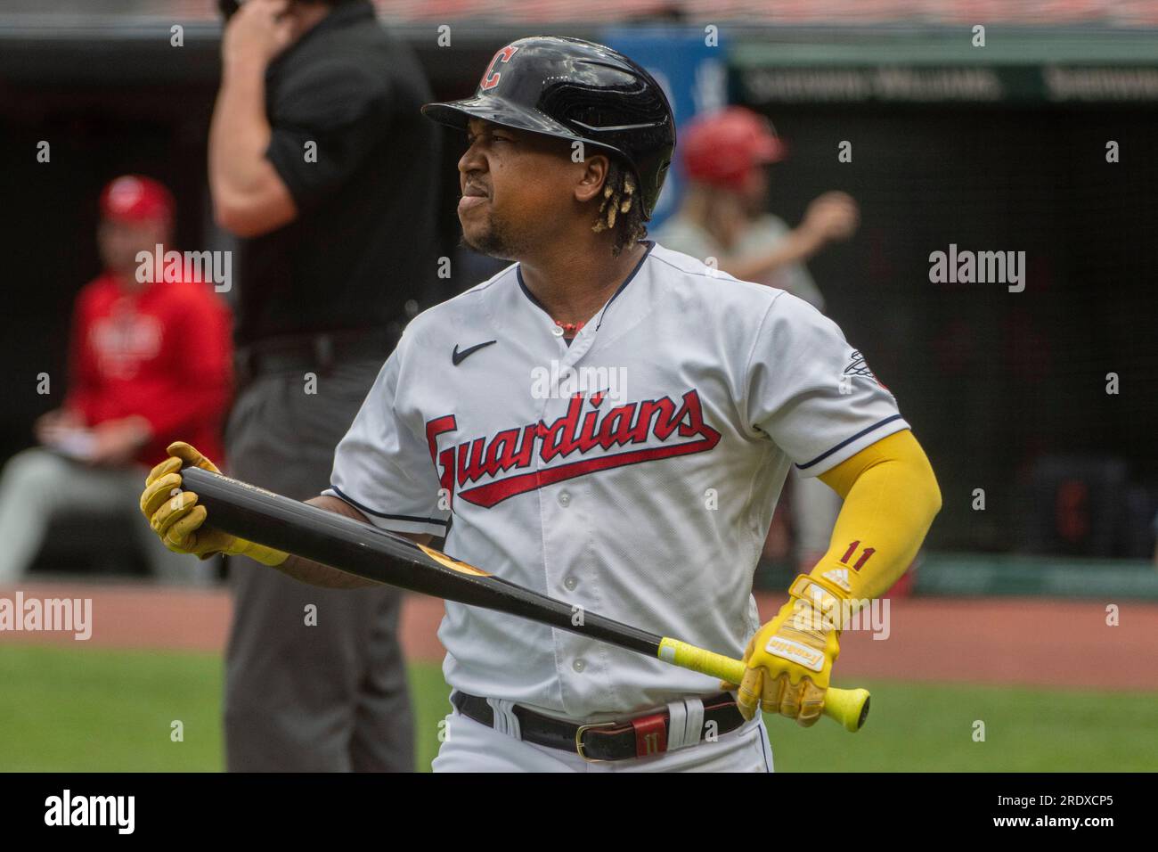 Minnesota Twins starting pitcher Josh Winder walks off the mound after  giving up a solo home run to Cleveland Guardians' Jose Ramirez, rounding  the bases in the background, during the first inning