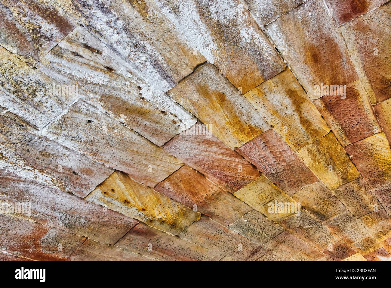 Colorful bricks fading from splashes of white to golden hues background
