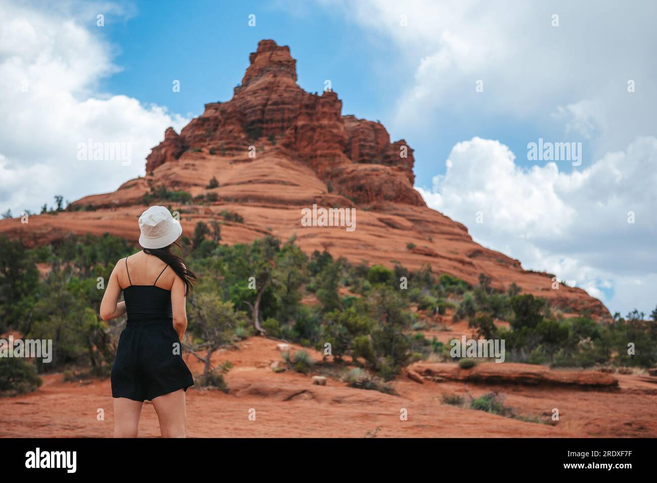Woman enjoys the view of the Sedona landscape from the top of the Bell