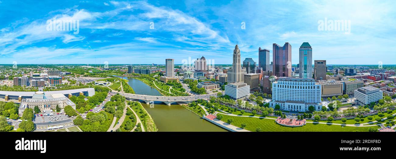 Aerial panorama downtown Columbus Ohio bright blue sky with clouds and bridge over Scioto river Stock Photo