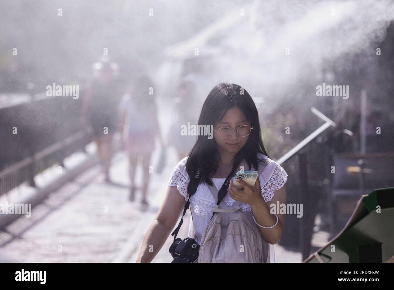 Athens greece 23rd july 2023 tourists walk next to a mist machine