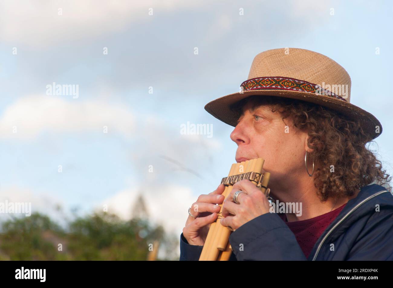 Retired woman in an Andean music course for the elderly in a nursing home in nature Stock Photo