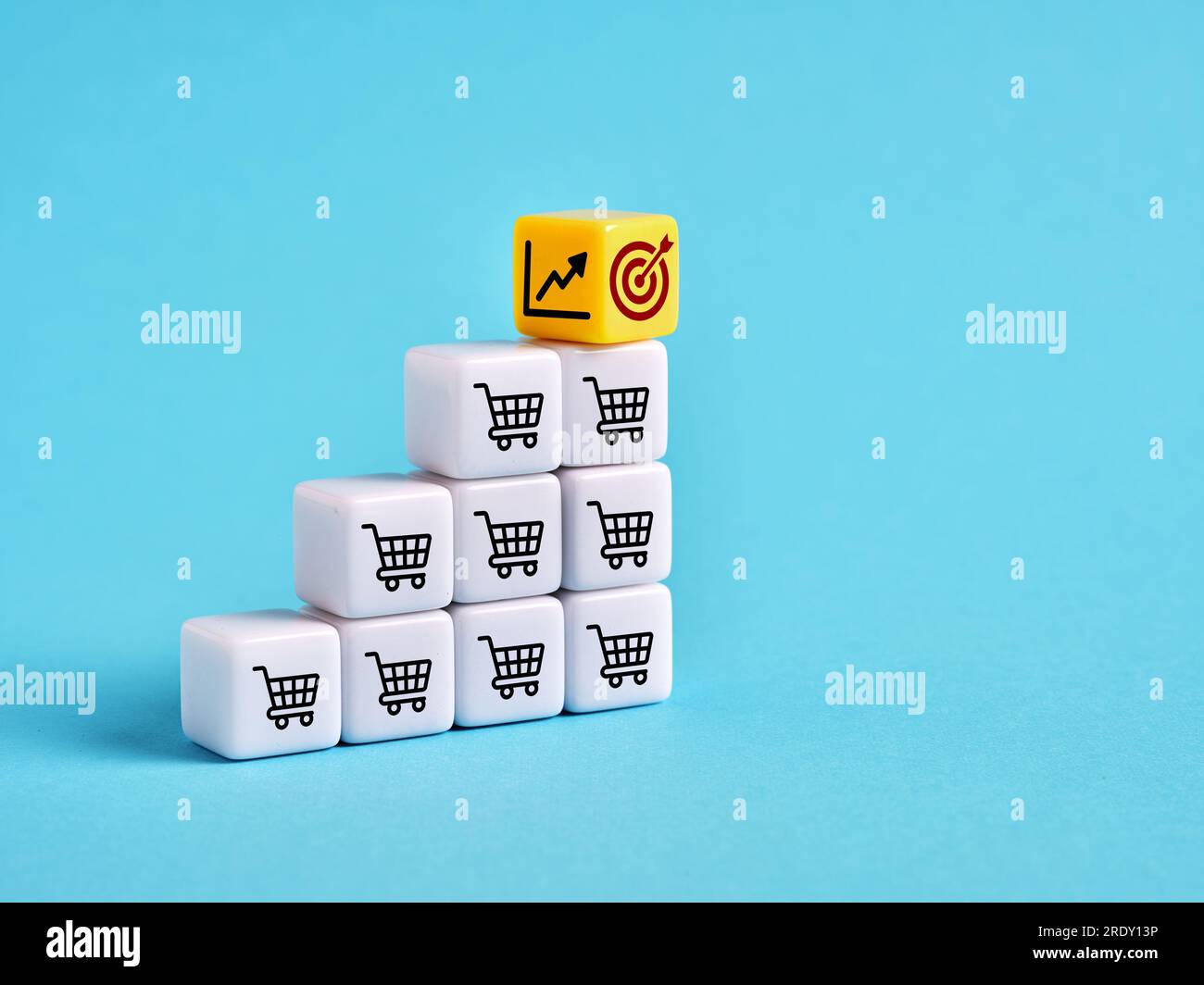 Achieving the sales goals and business growth. Setting the sales target objectives. Shopping cart, target and ascending graph symbols on cubes. Stock Photo