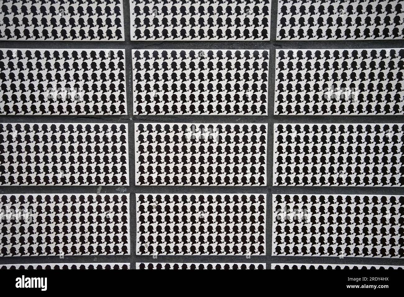 Close up Black and white wall tiles with Sherlock Holmes silhouette at Baker street underground station- London, United Kingdom Stock Photo