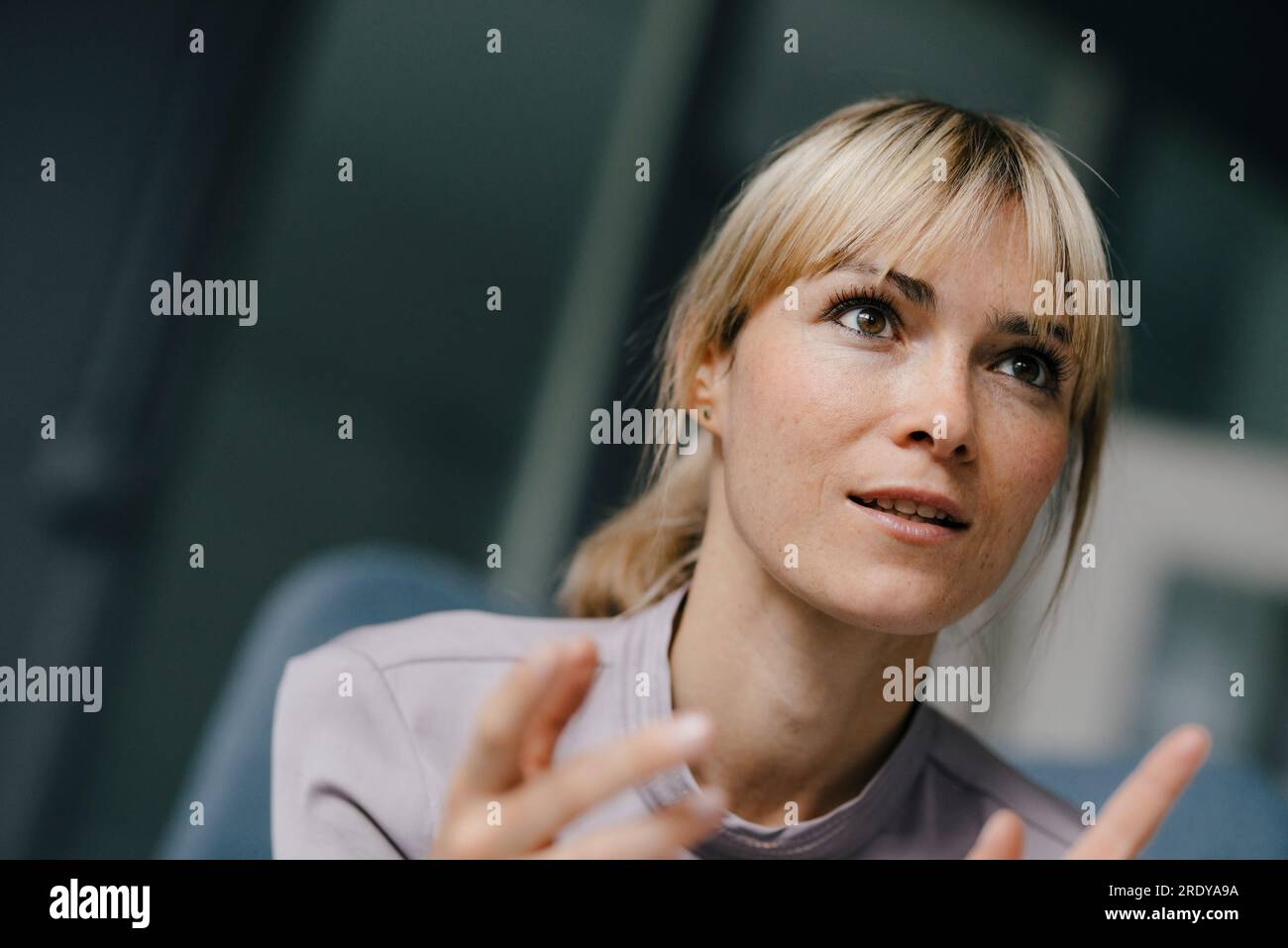 Portrait of a blond businesswoman, talking passionately Stock Photo