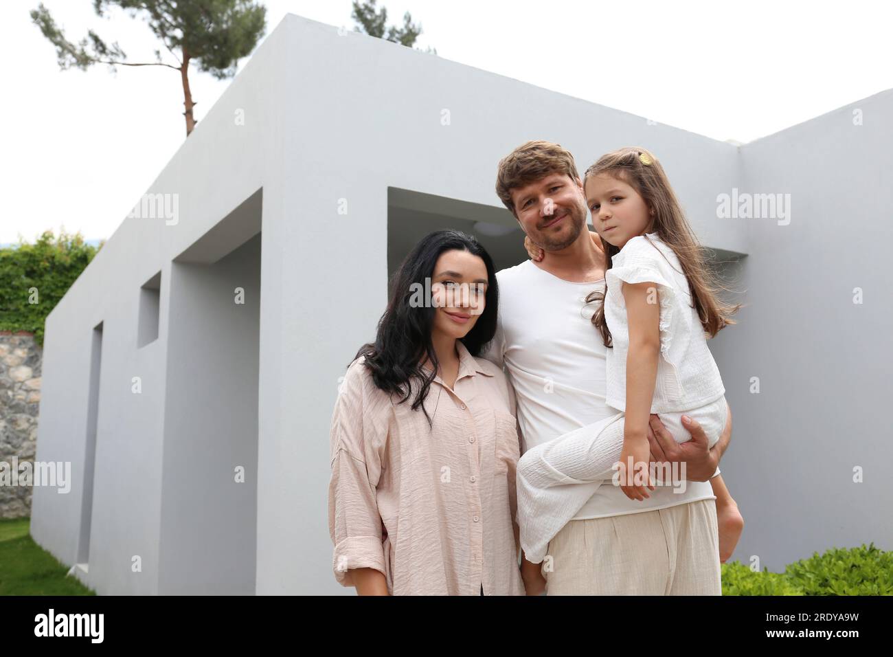 Family standing in front of house hi-res stock photography and images ...
