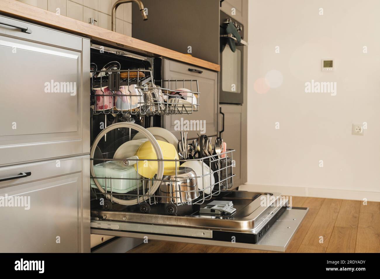 Clean dishes inside dishwasher in beautiful kitchen Stock Photo Alamy