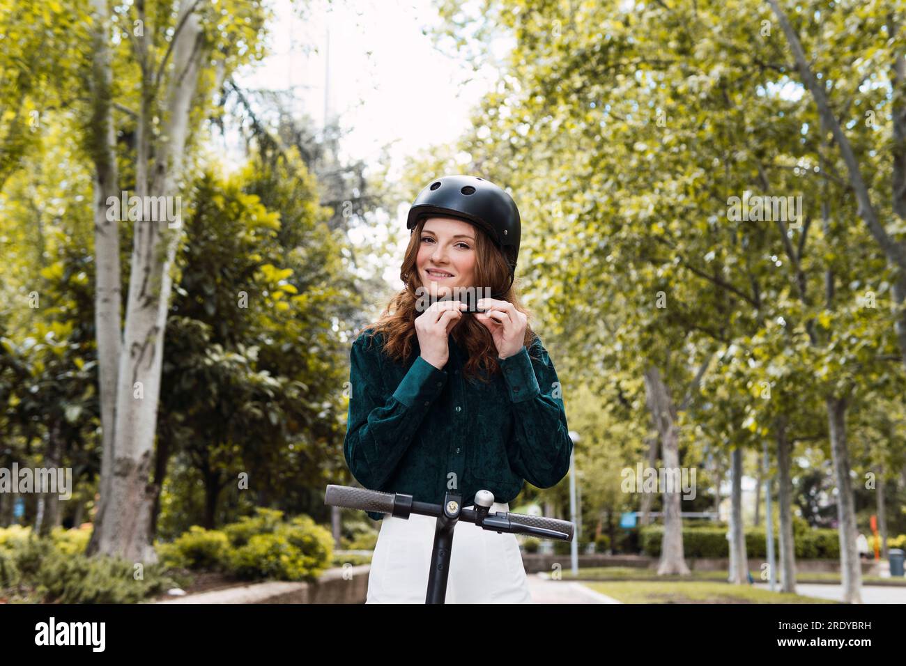 Young woman adjusting helmet hi-res stock photography and images - Alamy