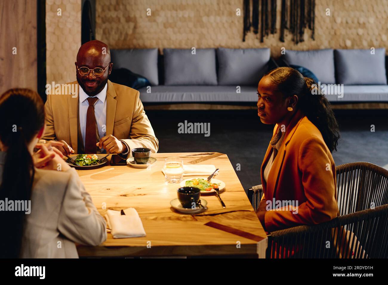 Discussing On Table Business colleagues discussing on dining table at convention center ...