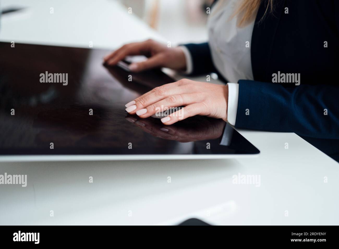 Hands of businesswoman working on graphics tablet in office Stock Photo