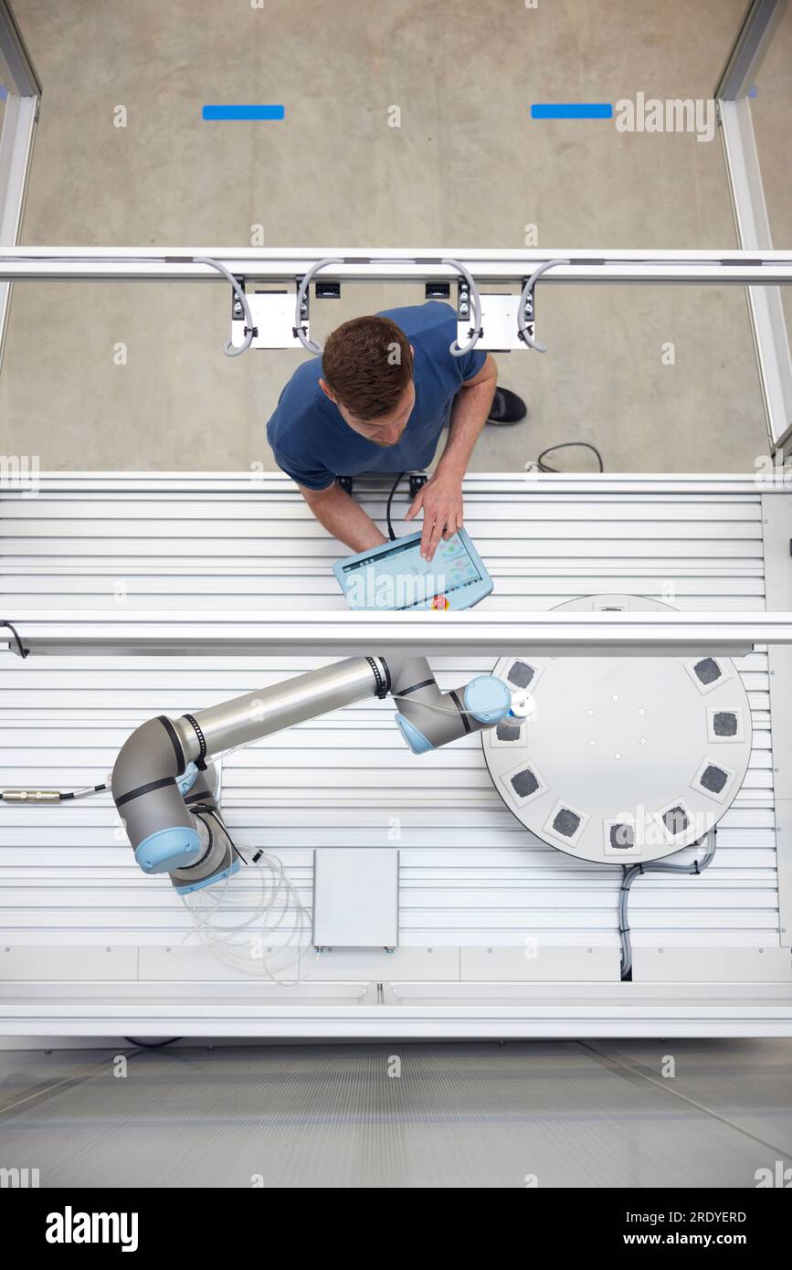 Engineer analyzing modern machine part in robotic industry Stock Photo ...