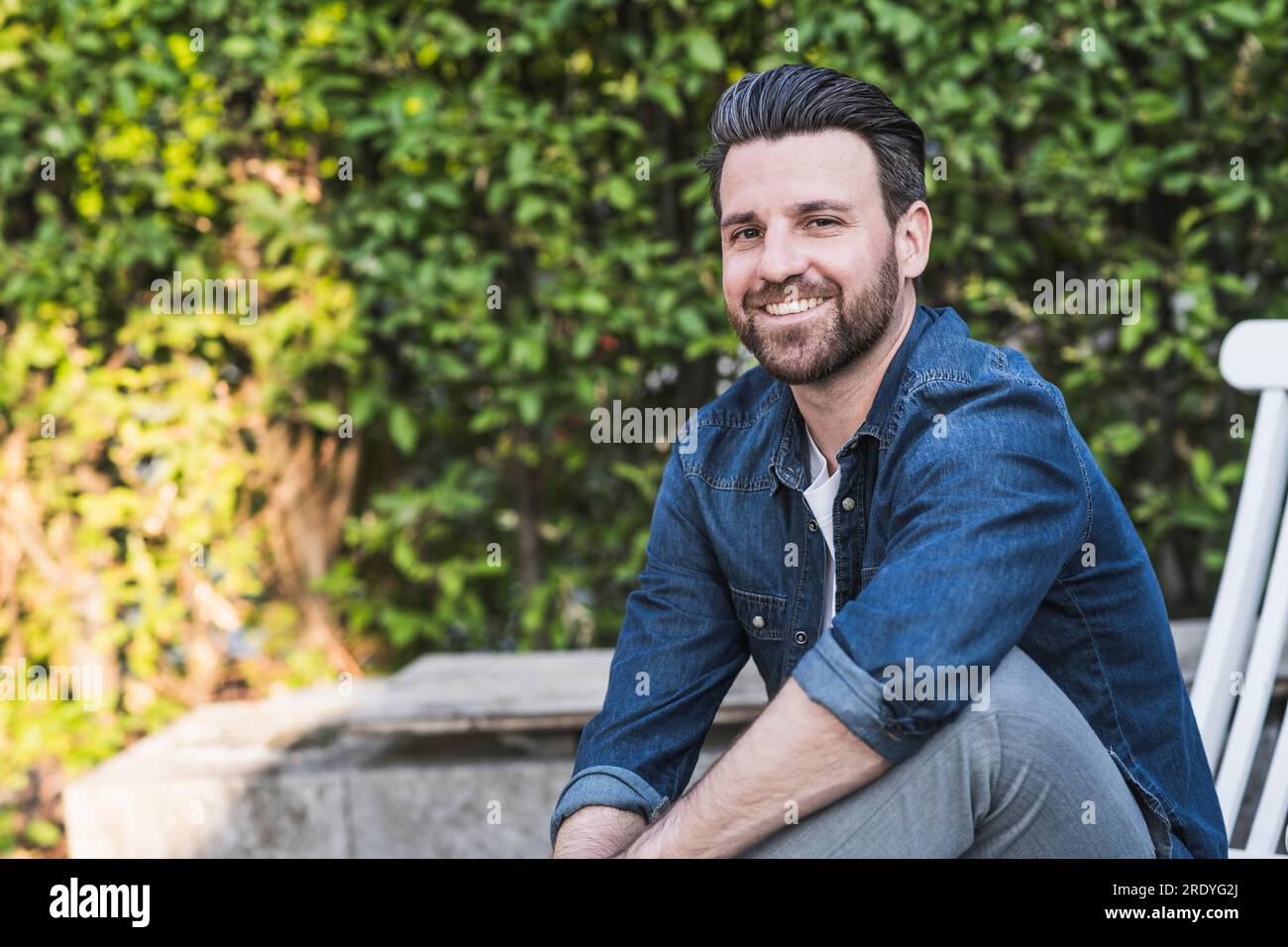 Happy man sitting in hi-res stock photography and images - Alamy