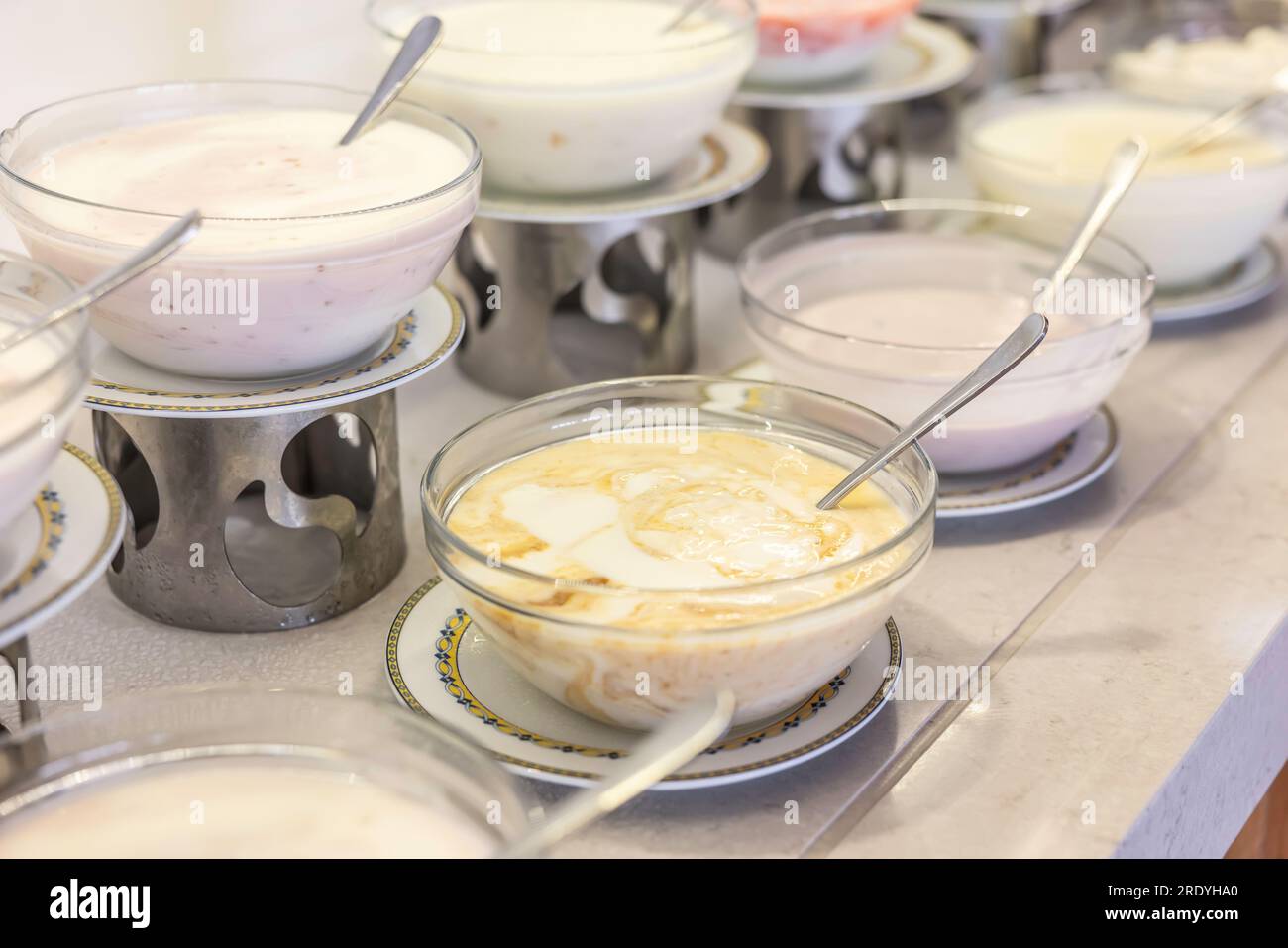 Yogurts in bowls on the buffet table in the hotel restaurant. Stock Photo