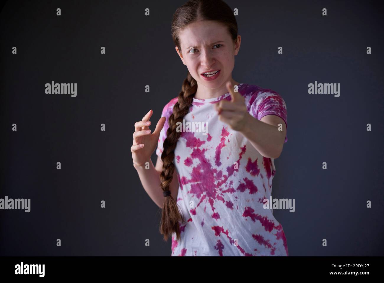 Studio Portrait Of Angry And Frustrated Teenage Girl Shouting At Camera Stock Photo