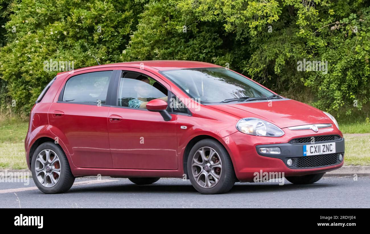 Milton Keynes,UK - July 21st 2023: 2011 red Fiat Punto hatchback car driving on an English road Stock Photo