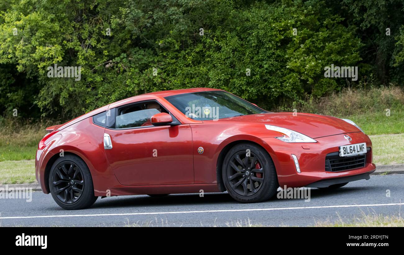 Milton Keynes,UK - July 21st 2023: 2015 red Nissan 370Z  car driving on an English road Stock Photo