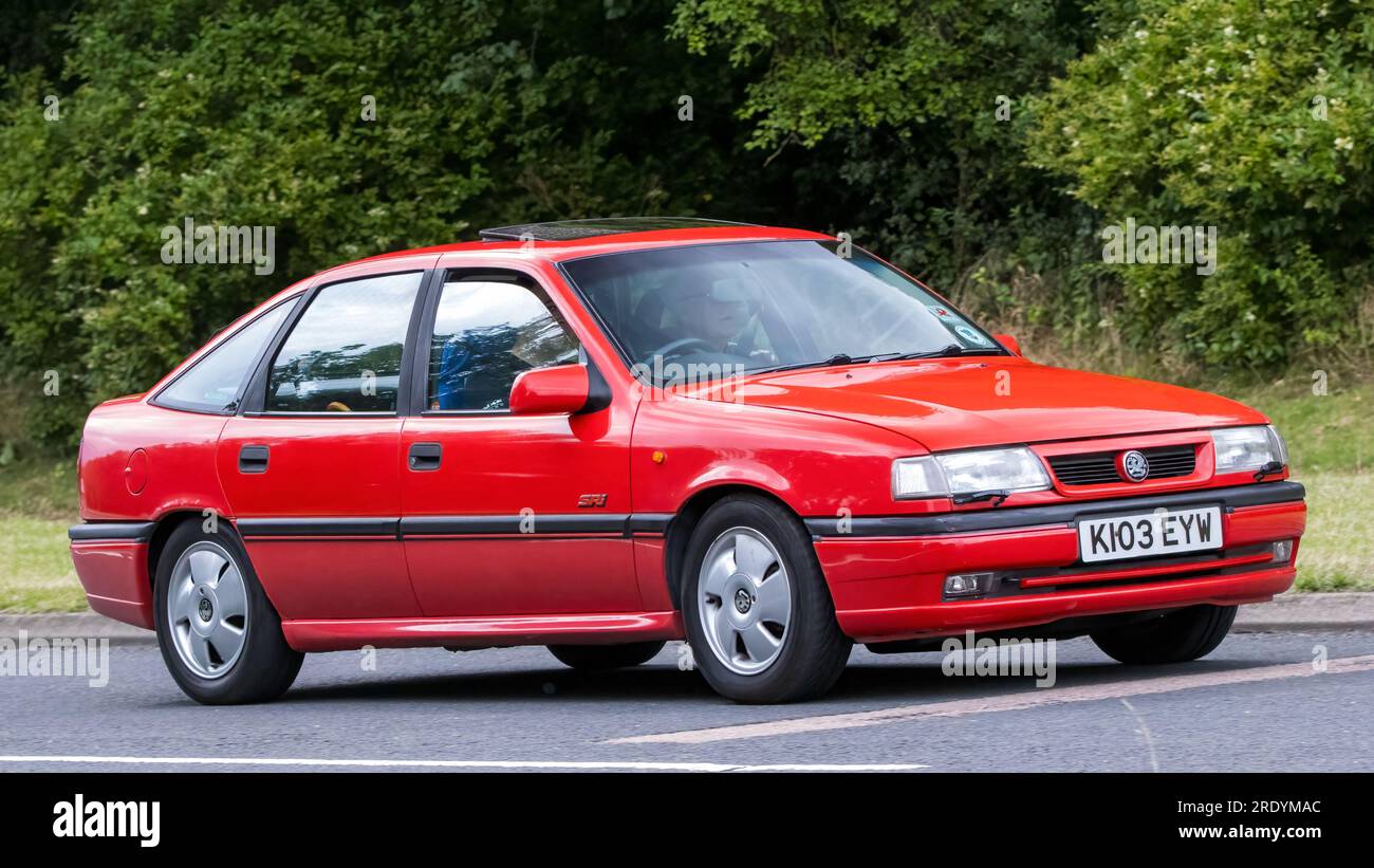Milton Keynes,UK - July 21st 2023: 1992 red Vauxhall Cavalier classic car driving on an English road Stock Photo