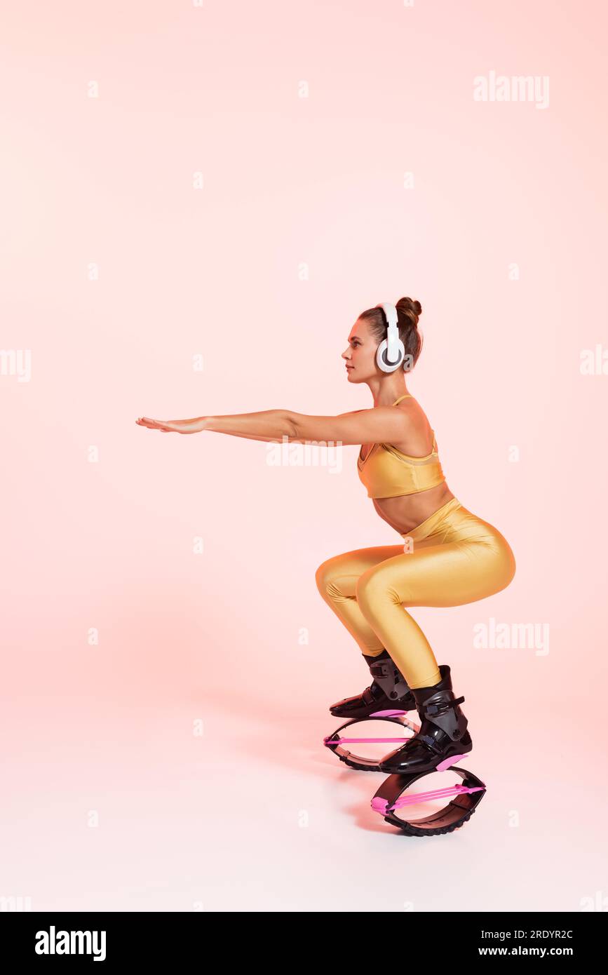 Female silhouette doing squat in kangoo jump boots