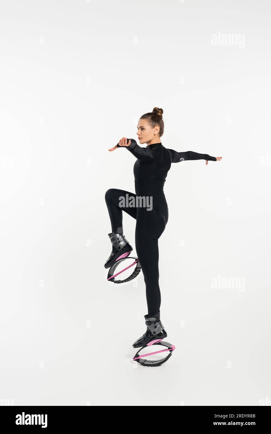 Female silhouette doing squat in kangoo jump boots