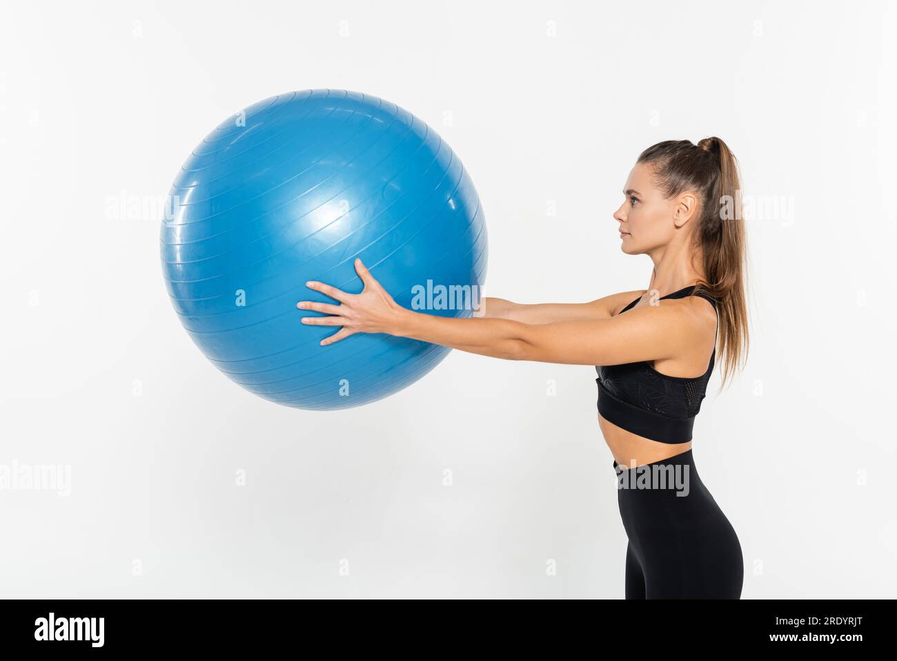 fit woman in active wear holding fitness ball isolated on white ...