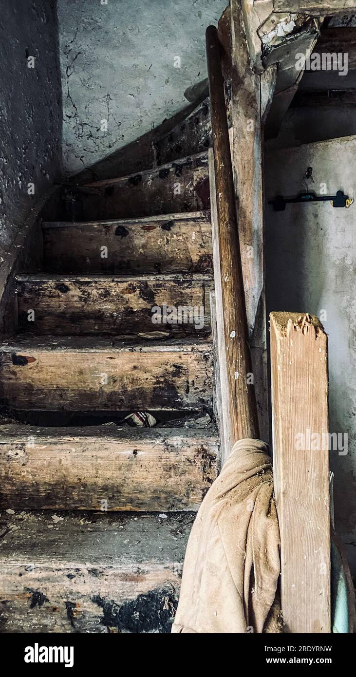 Decaying staircase. Suffolk, England: UNNERVING images of an abandoned rotting cottage that was spilling with jars of marmite have been captured. When Stock Photo