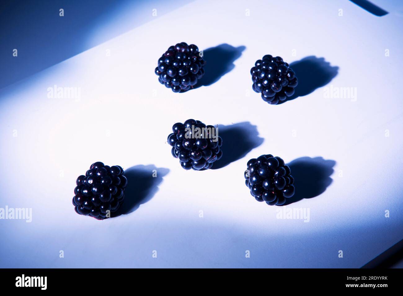 Blackberries lying on cutting board Stock Photo