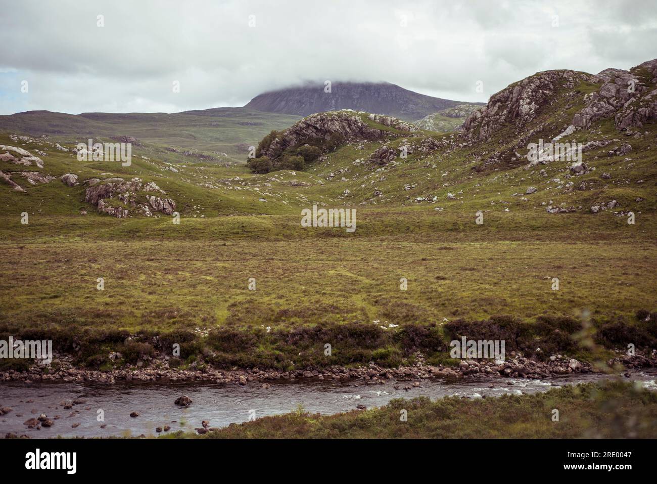 Remote River dramatic green landscape of remote river and mountain in highlands ...