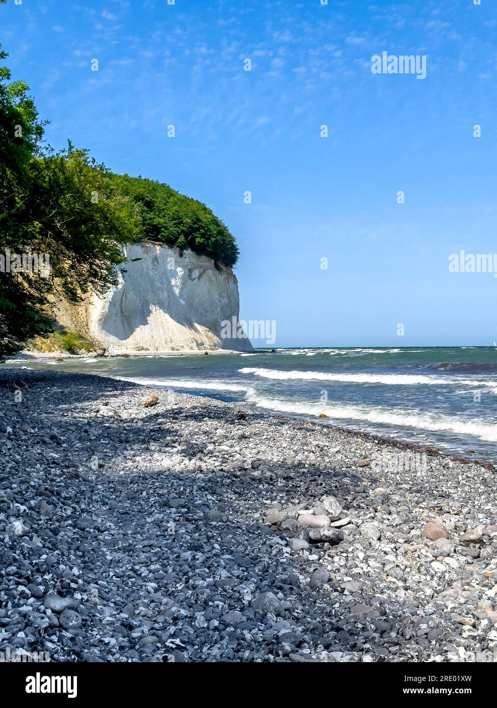 Waves in sea near coastline on empty pebble beach Stock Photo - Alamy