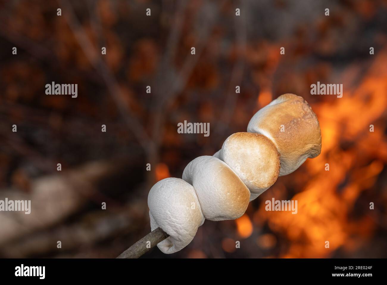Marshmallow cooked on the fire. Marshmallow bbq. Stock Photo