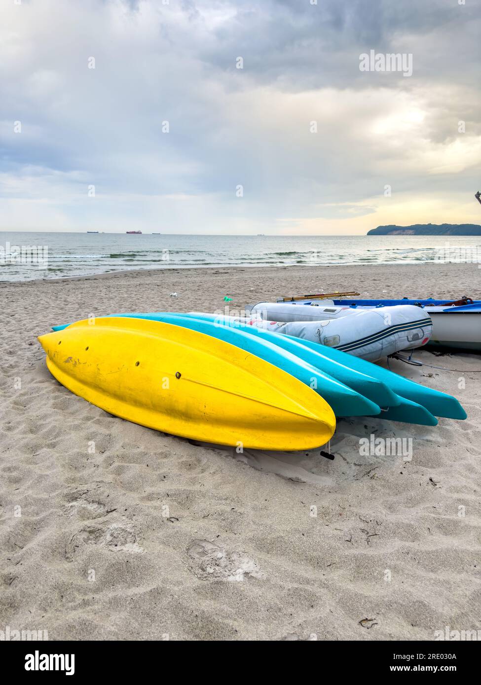 Tourist boats on an empty sandy beach Stock Photo - Alamy