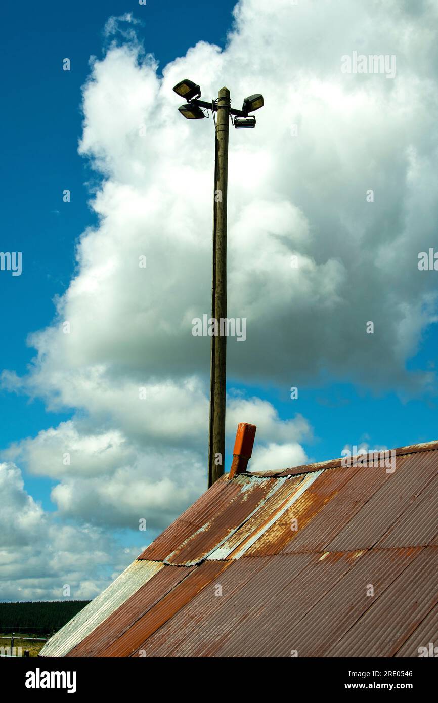 Lamppost and rusty tin roof. France Stock Photo