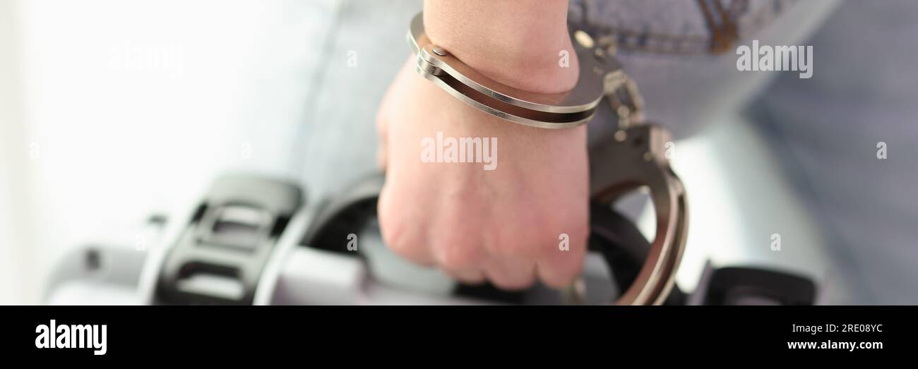 The hand is handcuffed to the baggage, a closeup Stock Photo Alamy