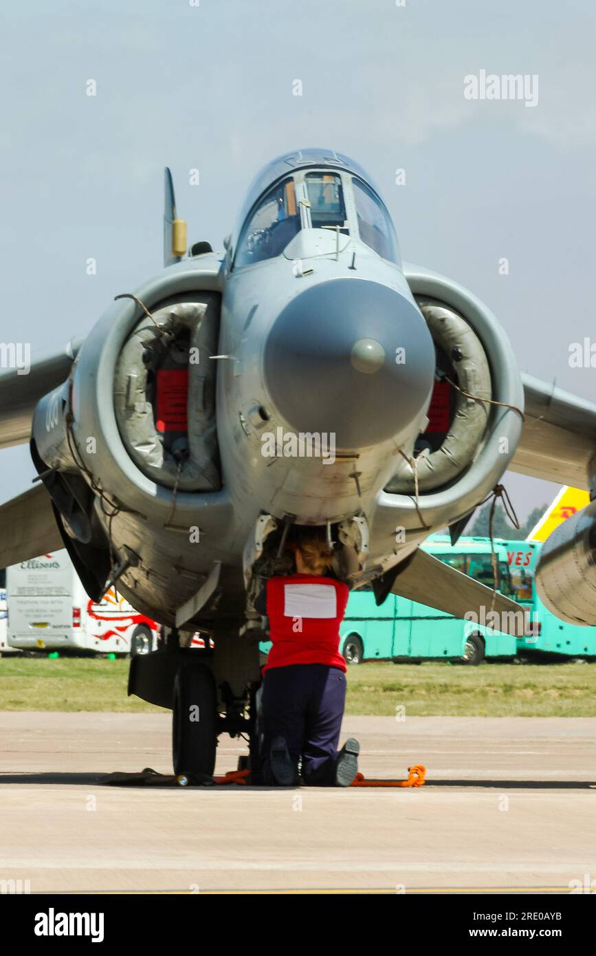 Royal Navy BAe Sea Harrier FA2 fighter jet plane at the Royal International Air Tattoo airshow, UK. Female engineer Stock Photo